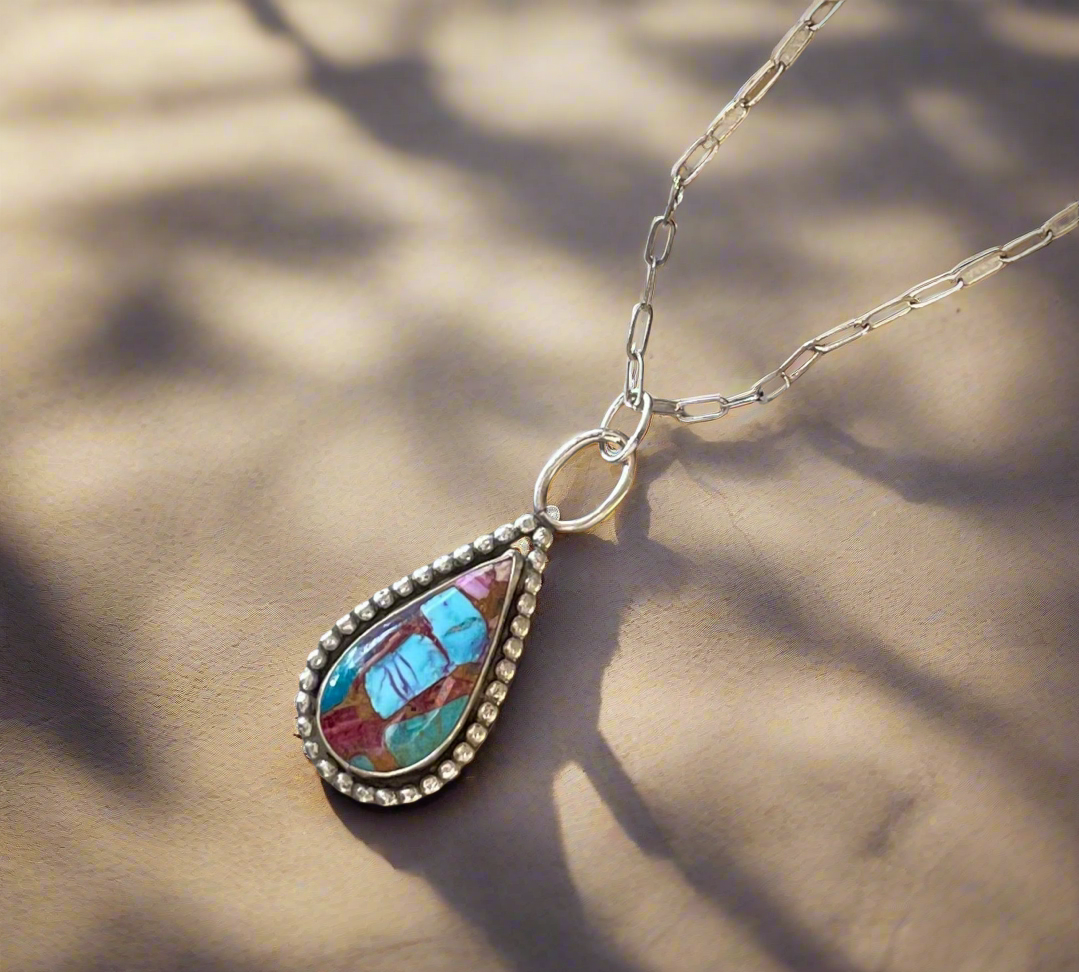 Composit turquoise set in sterling silver with beaded wire accent