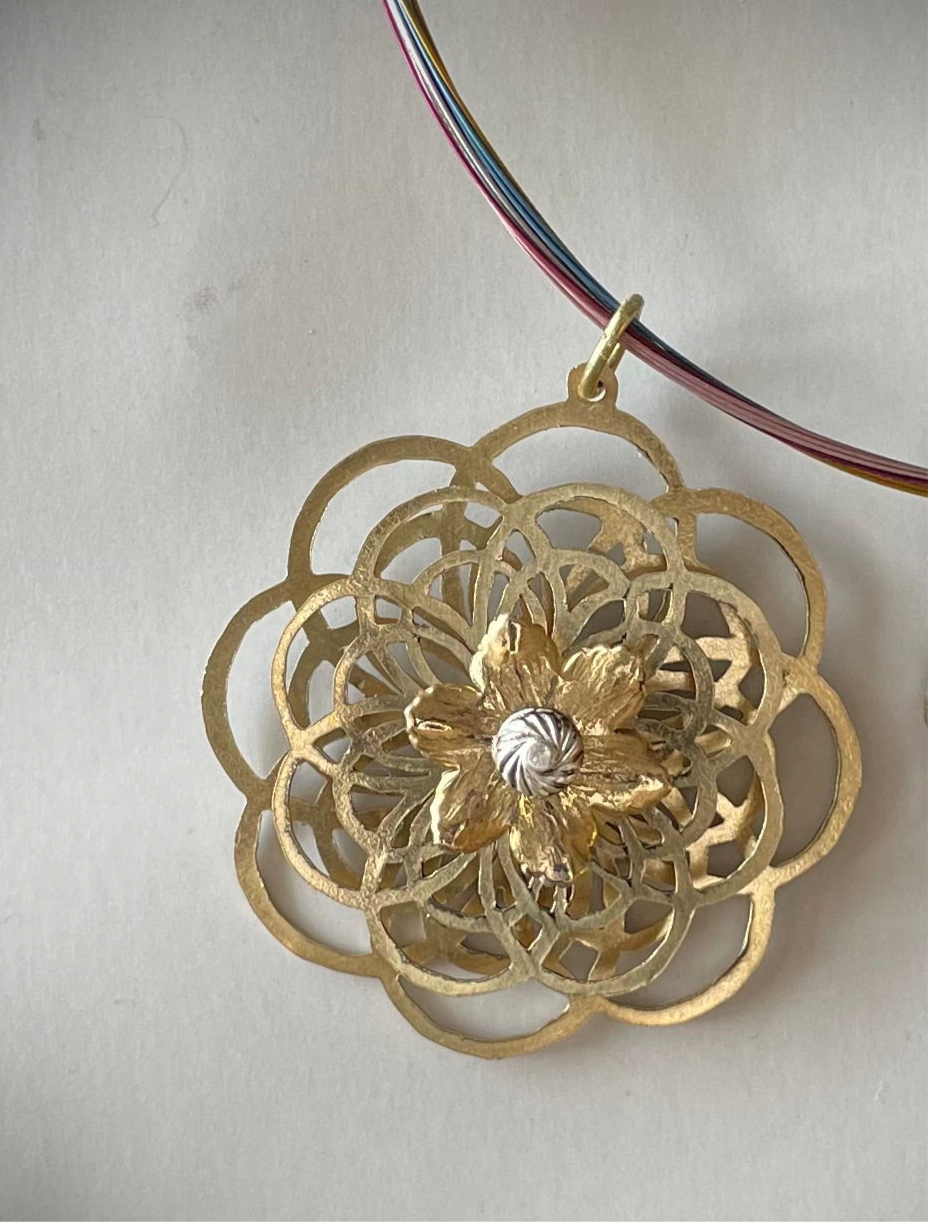 Kinetic flower hand sawed from brass