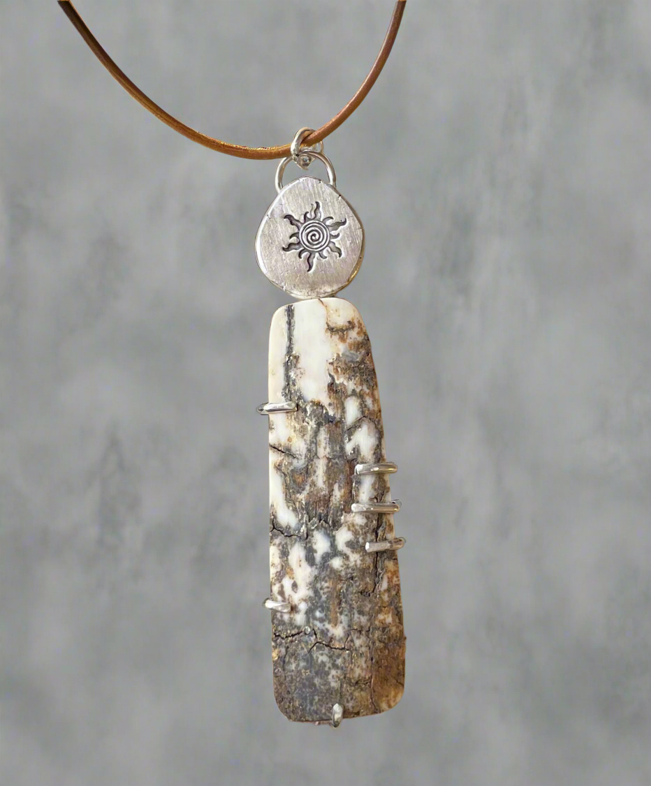 Rustic mammoth tusk with sterling silver sun stamped accent.