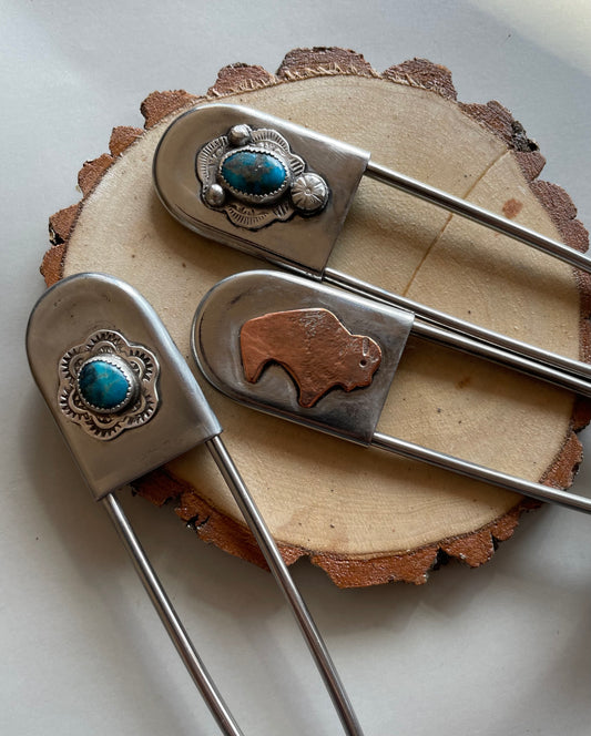 Blanket pin with turquoise, or a copper buffalo. 